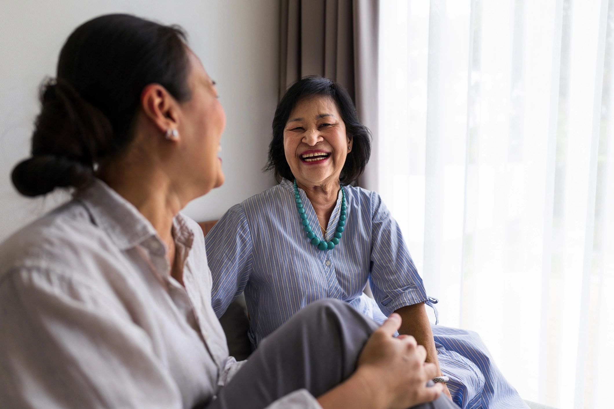 Older adult and caregiver sharing a conversation